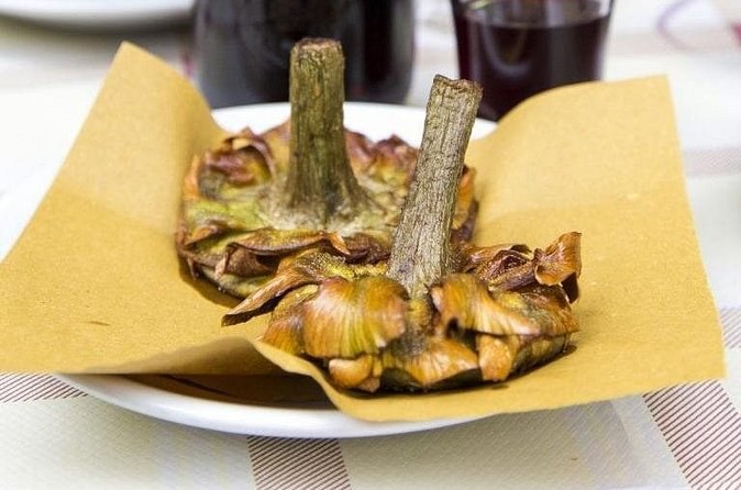 A Jewish-style fried artichoke, opened out flat on the plate