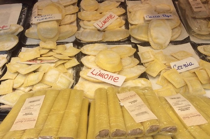 Fresh ravioli and pasta labelled by hand on a market stall