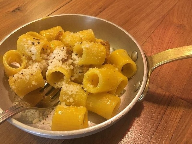 Rigatoni cacio e pepe, finished and served in the pan