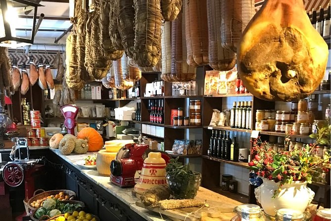 Inside a Roman salumeria, cured hams hanging above the counter