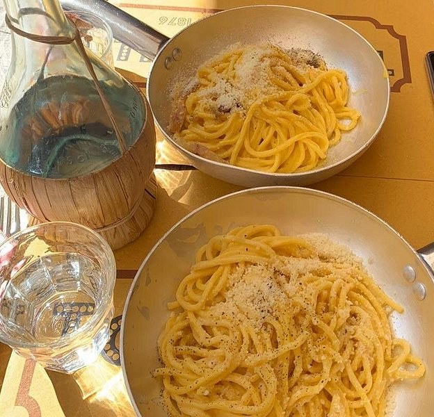 Two pans of Roman pasta on a kitchen table
